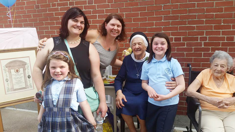 Sister Mary Angelus smiles with friends during her 90th birthday celebration.